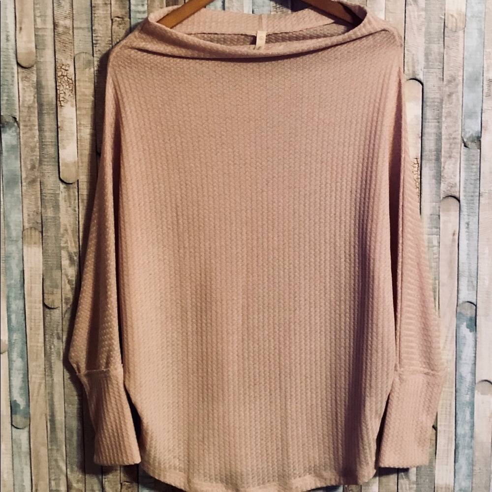 Short neck, loose fitting, long sleeved sweater